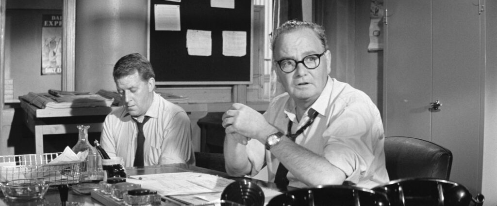 Real life Daily Express editor Arthur Christiansen chairs an urgent meeting with his reporting team