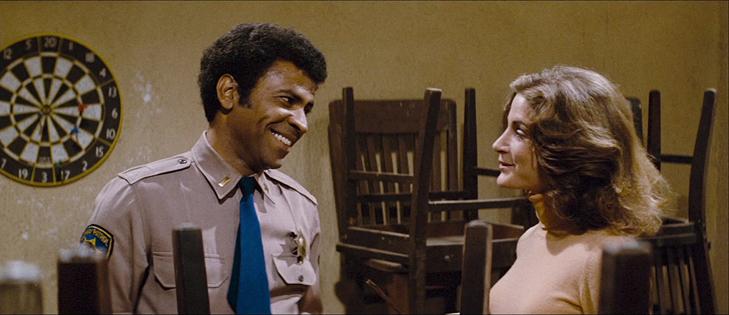 Bishop chats with Leigh (Laurie Zimmer).