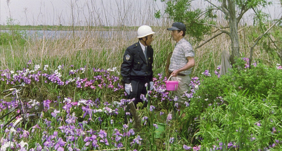 Takuro stands to attention for the local policeman