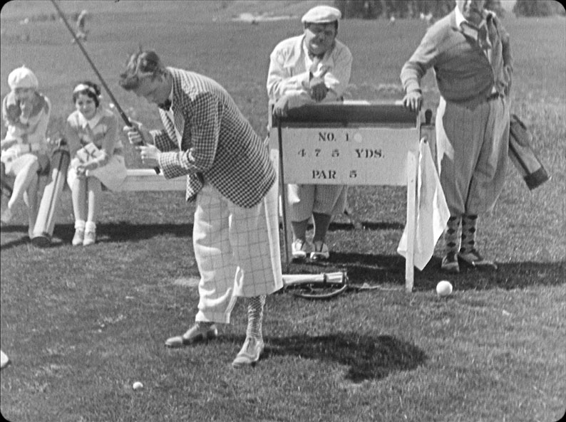 Stan attempts a shot as Ollie and Edgar Kennedy watch on