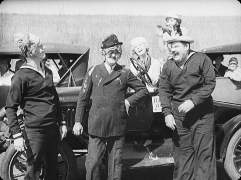 Stan and Ollie assault motorist Edgar Kennedy and delight their dates in Two Tars