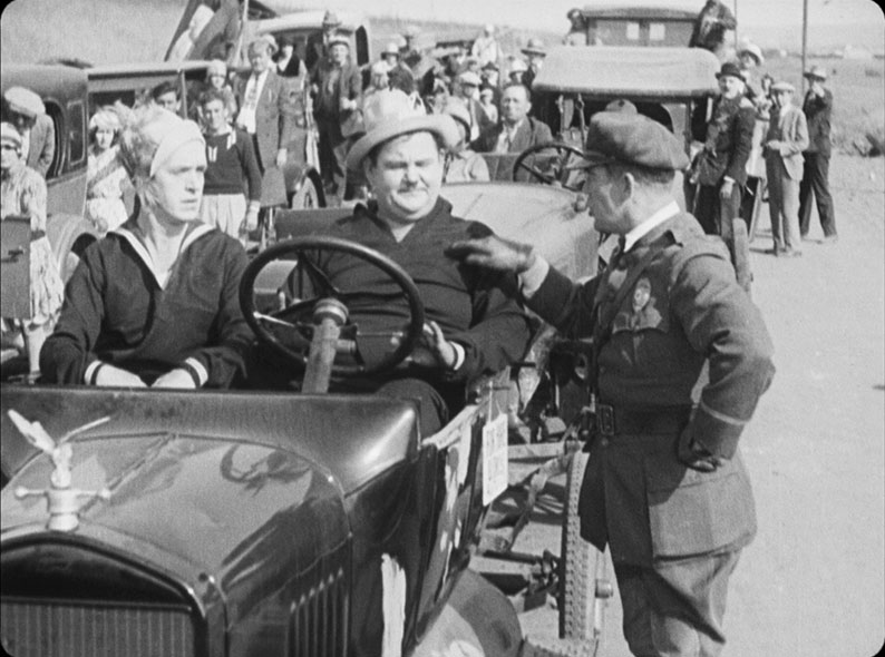 A motorcycle cop balls the boys out in Two Tars