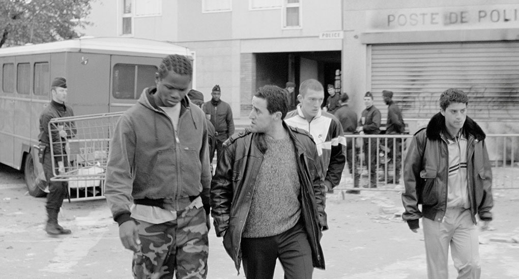 Samir leads Hubert, Vinz and Saïd out of the ransacked police station