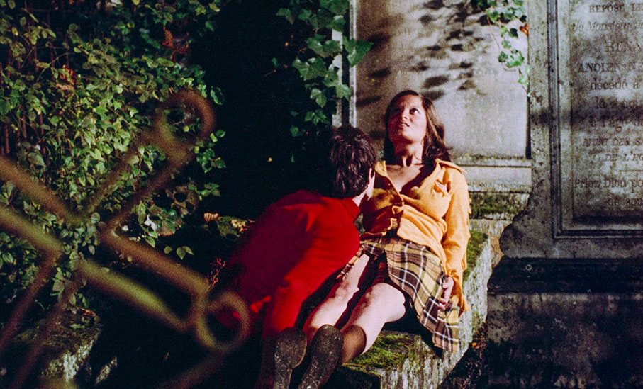 The boy reacts with alarm as the girl sits up in a trance and screams