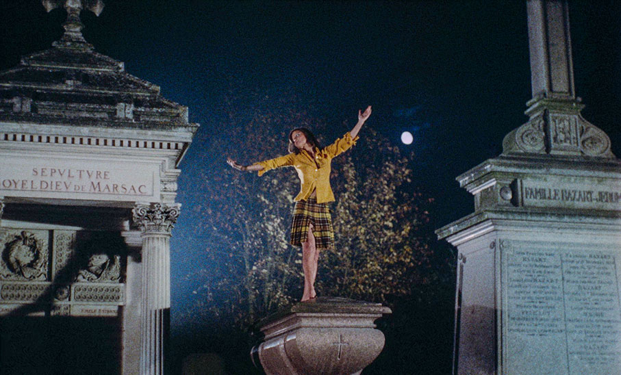 The girl dances through the cemetery