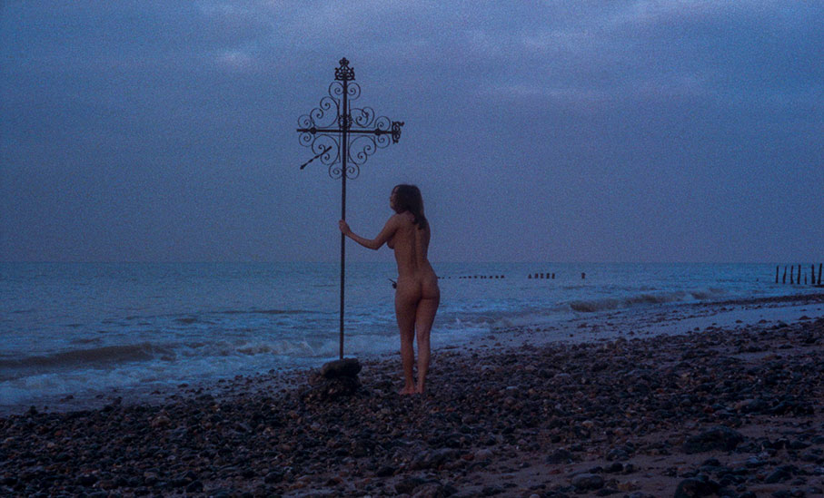 The girl has a vision of herself naked on a beach