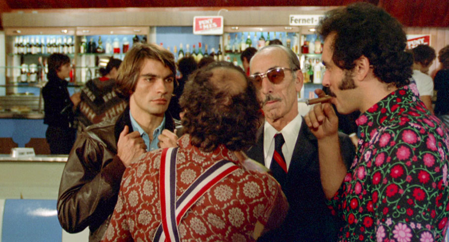 Malcarne and his unnamed associate meet with Rabal and Rio at the bowling alley