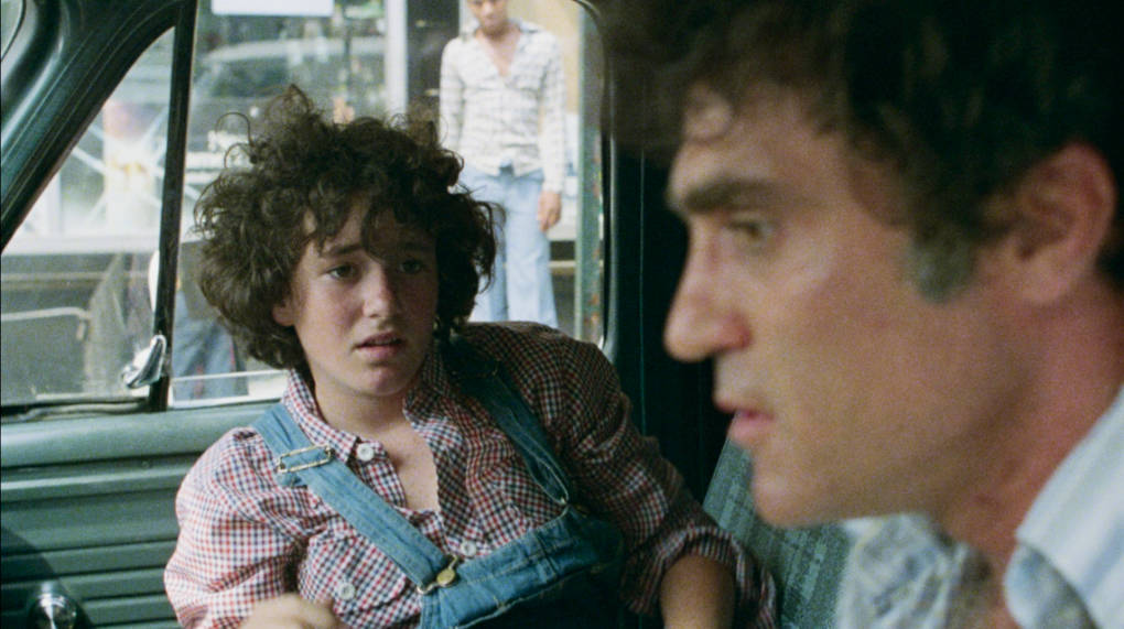 A scared Kathy watches as Gus hijacks a TV van