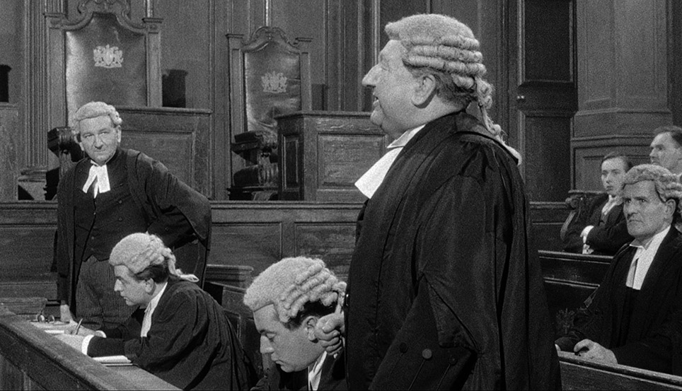 Antony Harcombe Q.C. interrogates a witness as the Attorney General watches on in frustration