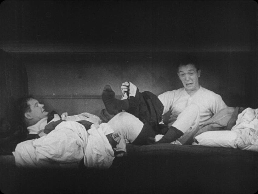 Stan and Ollie attempt to undress for bed in Berth Marks