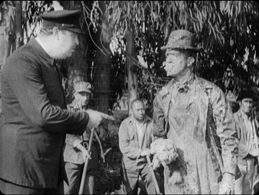 Stan readies to cake the guard in rice pudding in The Hoose-Gow
