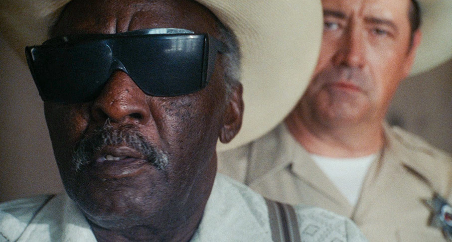 The sheriff looks on as Uncle Mort identifies Harry